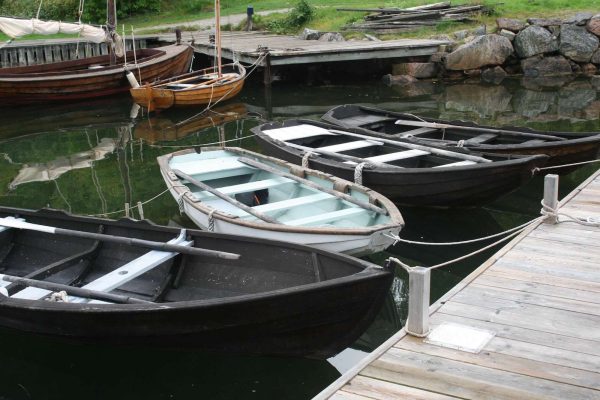 Allmogebåtar vid en brygga i en vik.